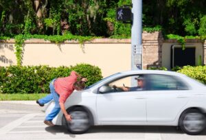 A pedestrian hit by a car