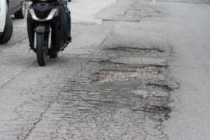 Motorcycle on poor road condition 