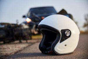 Helmet on the road after motorcycle and car accident