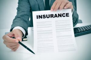 An Insurance Adjuster showing insurance policy to the claimant 