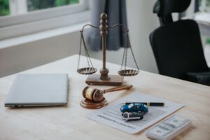 Lawyer office room with car model, money, documents and hammer