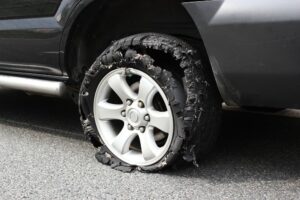 Damaged car tire after tire explosion at high speed