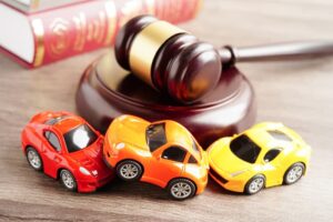 Three Car Models a judge's gavel on the table