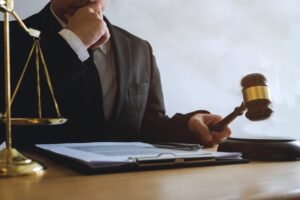 Lawyer working with car accident papers on the table in office.